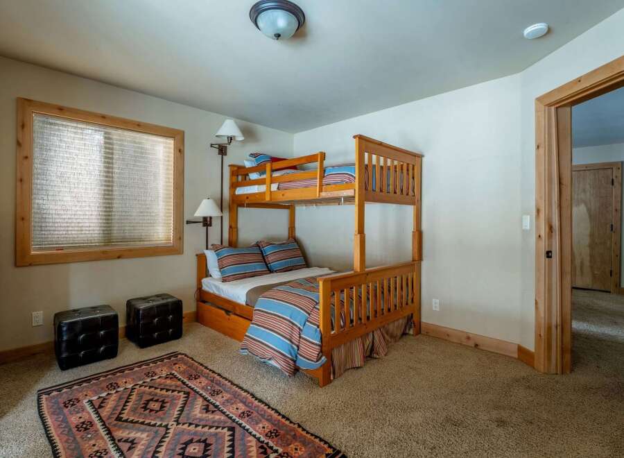 This charming bedroom features a cozy bunk bed, perfect for accommodating guests or family members.