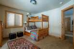 This charming bedroom features a cozy bunk bed, perfect for accommodating guests or family members.