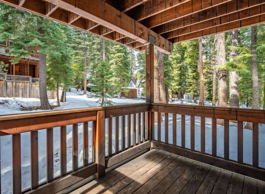 Enjoy the serene beauty of this stunning property, featuring a spacious deck that offers breathtaking views of the surrounding forest.