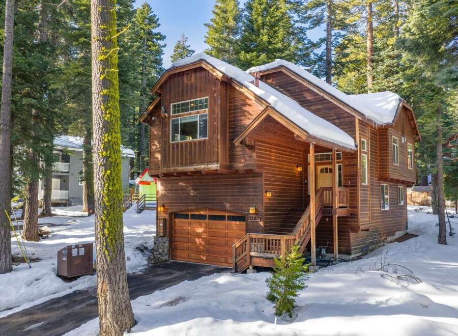 This stunning wooden cabin offers a cozy retreat in a serene, snow-covered setting.