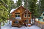 Nestled amidst a serene, snow-covered landscape, this charming wooden cabin offers a perfect blend of rustic charm and modern comfort.