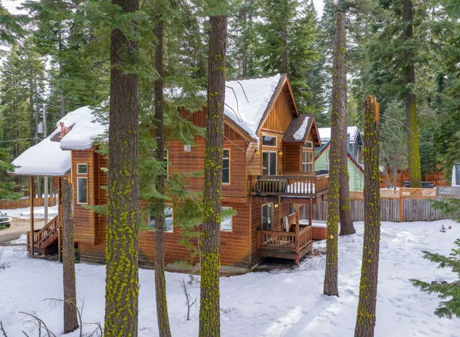 Nestled amidst a serene, snow-covered landscape, this stunning wooden home offers a perfect blend of rustic charm and modern comfort.
