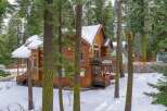 Nestled amidst a serene, snow-covered landscape, this stunning wooden home offers a perfect blend of rustic charm and modern comfort.