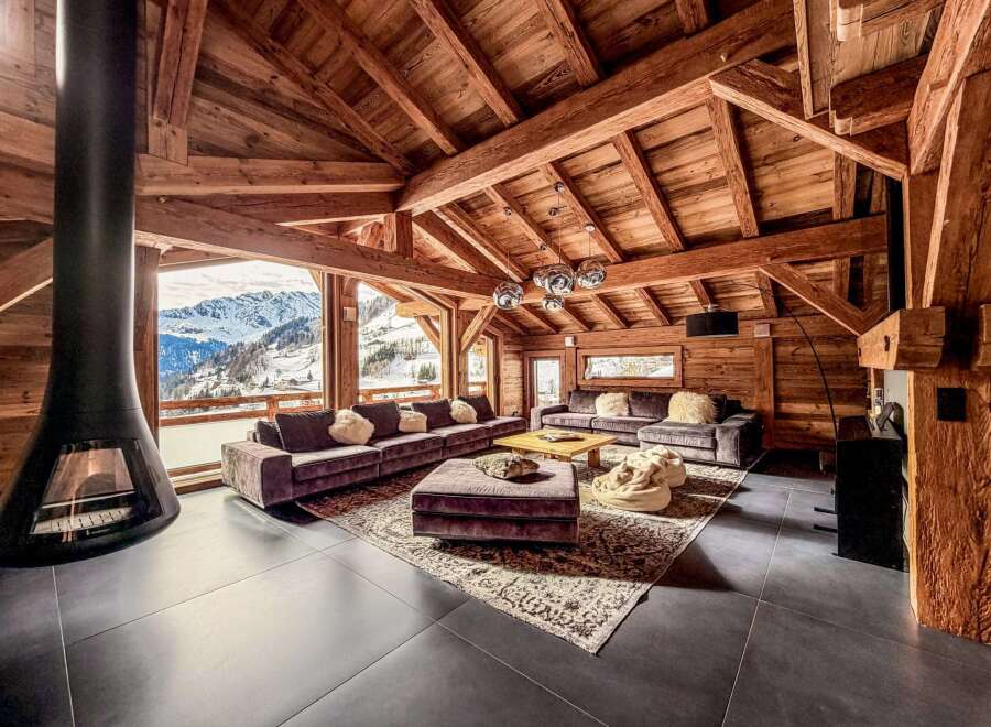 Experience luxury living in this stunning chalet, boasting a cozy fireplace and breathtaking mountain views.