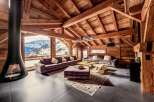 Experience luxury living in this stunning chalet, boasting a cozy fireplace and breathtaking mountain views.