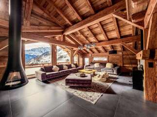 Experience luxury living in this stunning chalet, boasting a cozy fireplace and breathtaking mountain views.