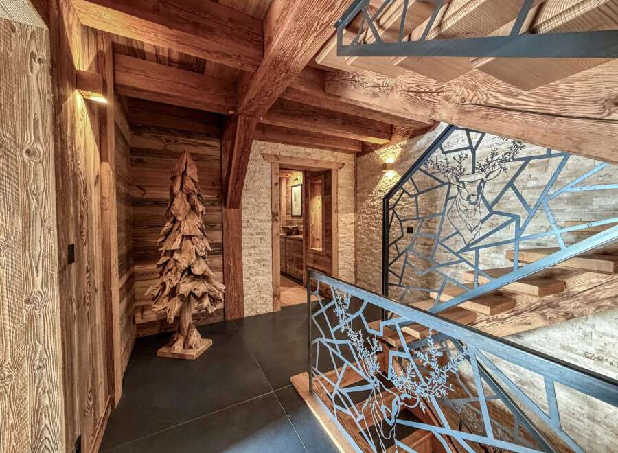 Step into rustic elegance with this stunning property, showcasing exquisite wooden beams and a unique wooden tree sculpture.