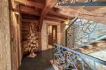 Step into rustic elegance with this stunning property, showcasing exquisite wooden beams and a unique wooden tree sculpture.