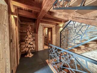 Step into rustic elegance with this stunning property, showcasing exquisite wooden beams and a unique wooden tree sculpture.