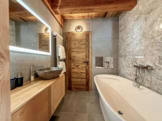 Experience luxury in this stunning bathroom, featuring a sleek, modern design.