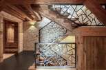 Step into rustic elegance with this stunning property featuring a beautifully crafted staircase.