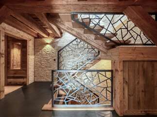 Step into rustic elegance with this stunning property featuring a beautifully crafted staircase.