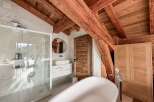 Experience luxury in this stunning bathroom featuring a modern design and rustic charm.