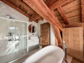 Experience luxury in this stunning bathroom featuring a modern design and rustic charm.