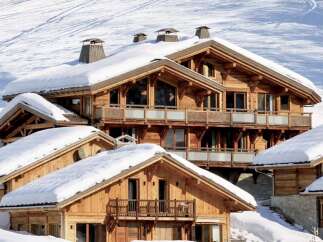 Experience the epitome of luxury living in this stunning chalet nestled in a snowy mountain landscape.
