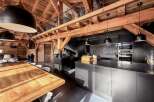 Experience rustic elegance in this stunning property featuring exposed wooden beams and a modern kitchen.