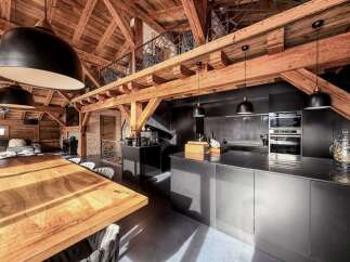 Experience rustic elegance in this stunning property featuring exposed wooden beams and a modern kitchen.