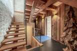 Step into rustic elegance with this stunning property featuring a beautifully crafted wooden staircase and exposed beams.