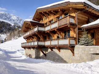 Experience the epitome of alpine luxury in this stunning wooden chalet.