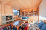 This cozy living room features a stunning stone fireplace, perfect for chilly evenings.