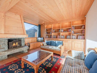 This cozy living room features a stunning stone fireplace, perfect for chilly evenings.