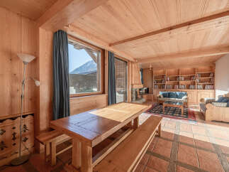 This stunning property boasts a warm and inviting interior with beautiful wooden accents throughout.