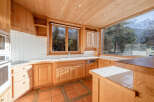 This stunning kitchen boasts a warm, inviting atmosphere with its natural wood cabinetry and tiled backsplash.
