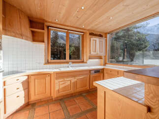 This stunning kitchen boasts a warm, inviting atmosphere with its natural wood cabinetry and tiled backsplash.