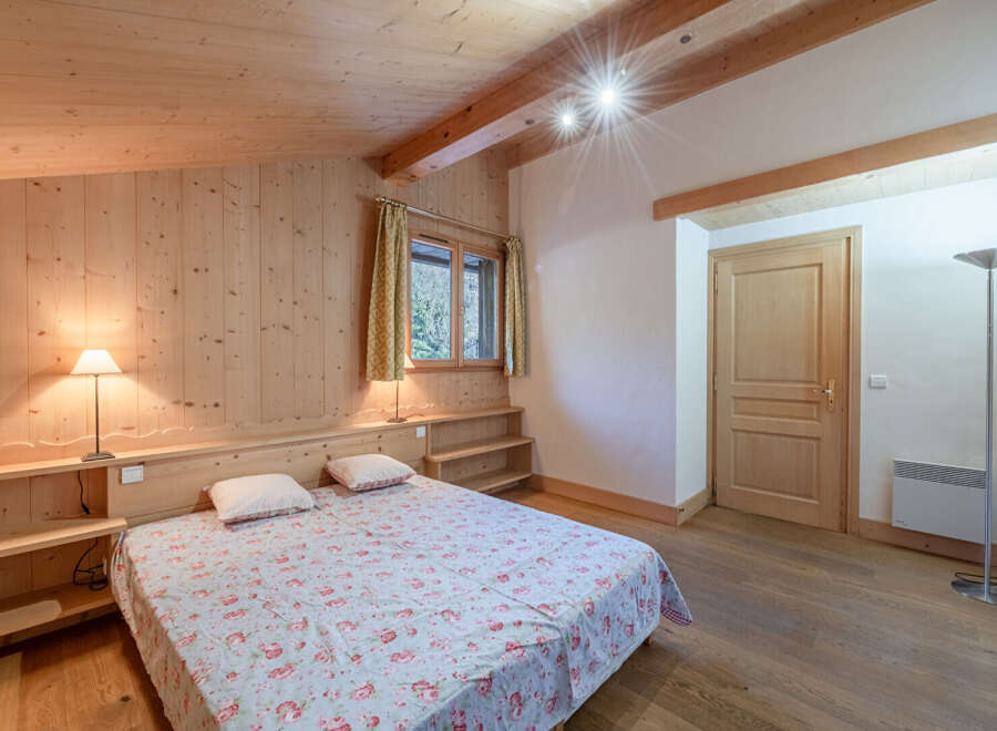 This cozy bedroom features a warm wooden interior, creating a rustic and inviting atmosphere.