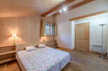 This cozy bedroom features a warm wooden interior, creating a rustic and inviting atmosphere.