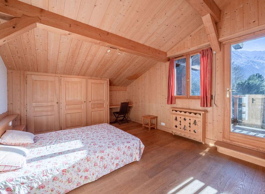 This charming bedroom features a cozy wooden interior, creating a warm and inviting atmosphere.