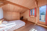 This charming bedroom features a cozy wooden interior, creating a warm and inviting atmosphere.