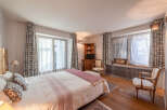 This charming bedroom offers a cozy and inviting atmosphere, perfect for relaxation.