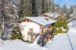 Nestled in a serene winter wonderland, this charming chalet offers a perfect blend of rustic elegance and modern comfort.
