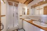 This charming bathroom features a glass-enclosed shower, perfect for a refreshing start to your day.