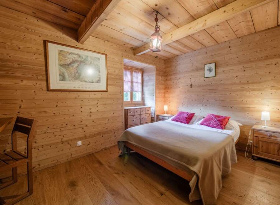 Step into a cozy bedroom retreat with stunning wood paneling and a warm, inviting ambiance.