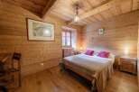 Step into a cozy bedroom retreat with stunning wood paneling and a warm, inviting ambiance.