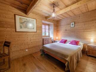 Step into a cozy bedroom retreat with stunning wood paneling and a warm, inviting ambiance.