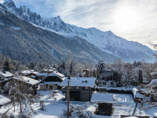 Nestled in a picturesque winter wonderland, this charming property offers stunning views of snow-capped mountains.
