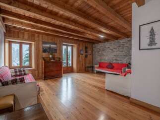 This stunning property boasts a warm and inviting interior with beautiful wooden floors and ceilings.