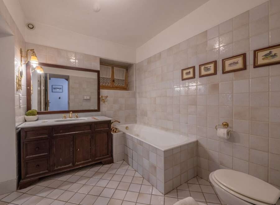 Step into this elegant bathroom featuring classic design elements and luxurious finishes.