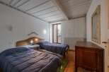 This charming bedroom features two twin beds with cozy blue bedding, perfect for a comfortable stay.