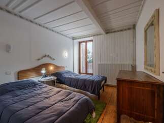 This charming bedroom features two twin beds with cozy blue bedding, perfect for a comfortable stay.