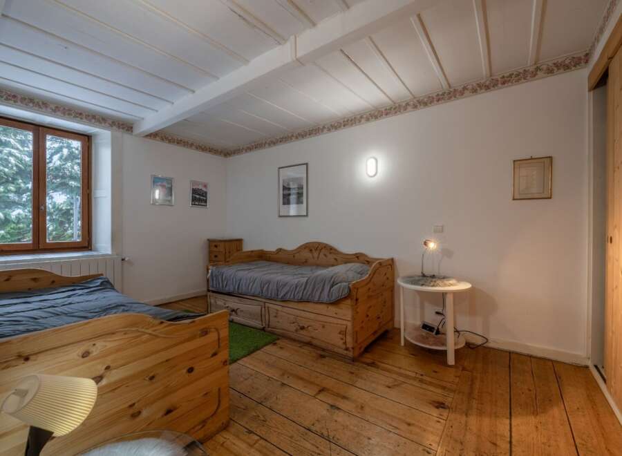 This charming bedroom features rustic wooden furniture and a cozy atmosphere.