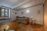 This charming bedroom features rustic wooden furniture and a cozy atmosphere.