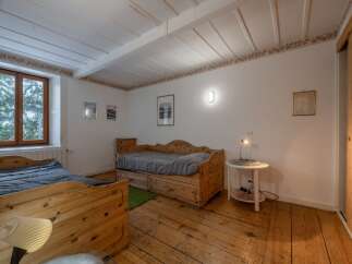 This charming bedroom features rustic wooden furniture and a cozy atmosphere.