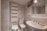 This charming bathroom features a classic design with tiled walls and a pedestal sink.