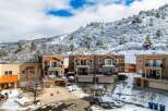 Discover luxury living in this stunning townhome community nestled against a snow-covered mountain backdrop.