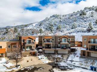 Discover luxury living in this stunning townhome community nestled against a snow-covered mountain backdrop.