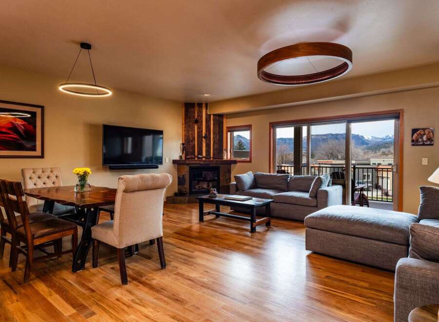 Experience luxury living in this stunning property, featuring a cozy fireplace and a modern entertainment setup.
